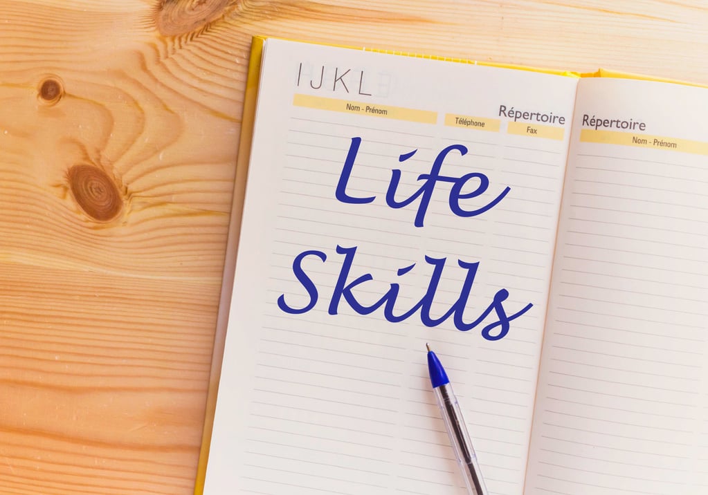 Life skills text on open notebook on wooden table